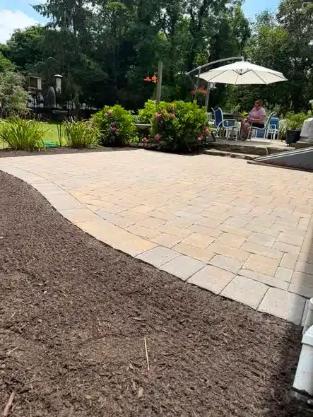 Ideal Block Yankee Cobble herringbone hardscaping installation in Groton, CT by Spicer’s Lawn Care & Landscape Design.