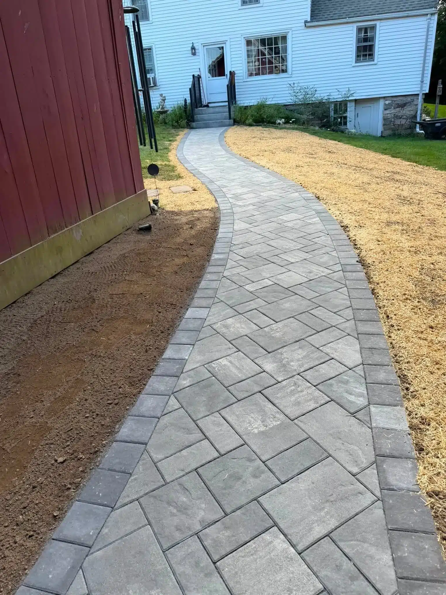 Professionally installed Unilock paver walkway creating a durable and attractive outdoor path in Preston, CT.